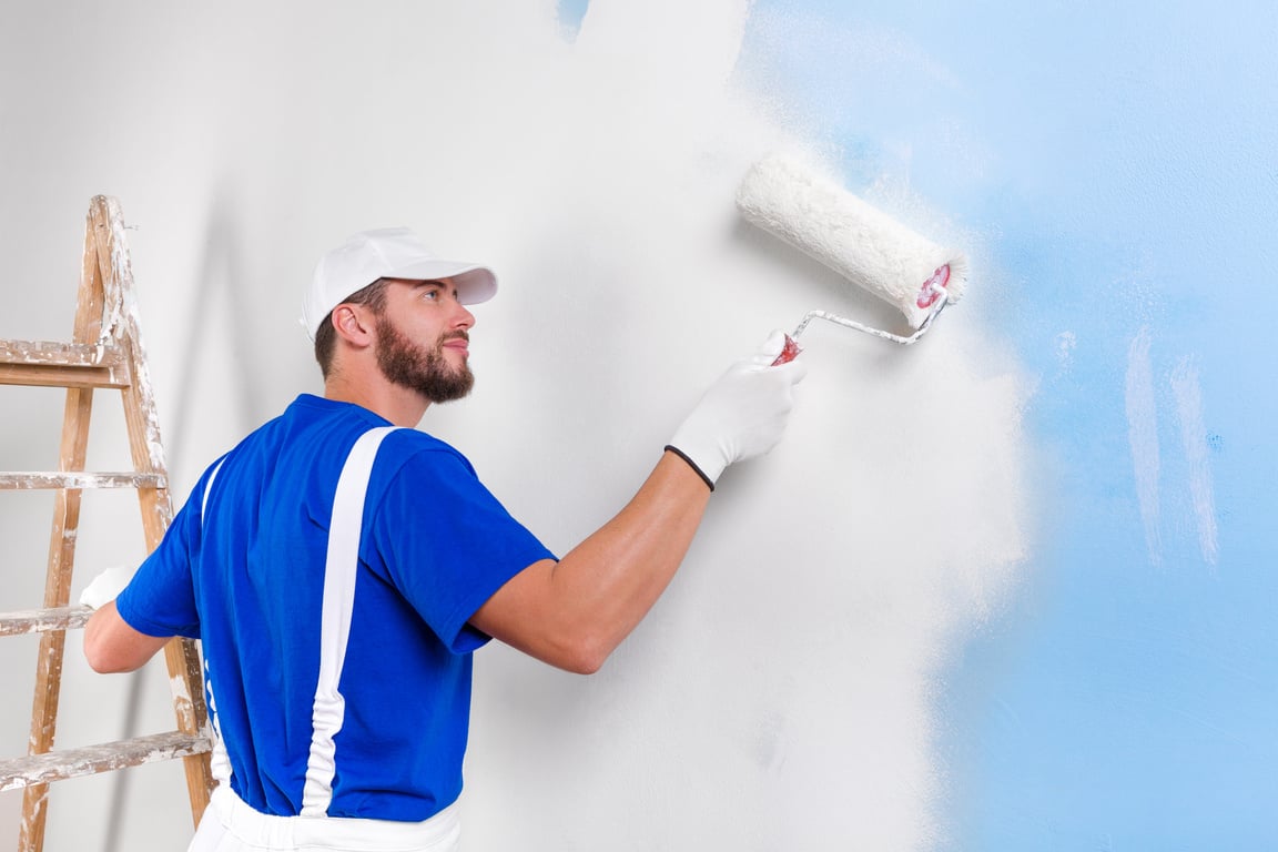 painter in white dungarees, blue t-shirt