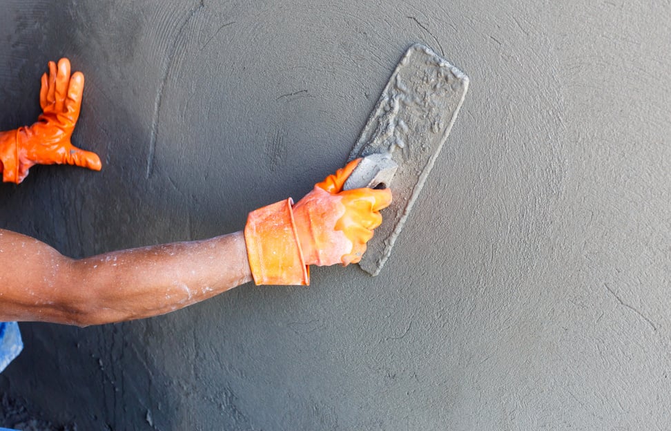 Construction worker by wall of house